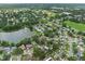 Neighborhood aerial with pond view and surrounding amenities including nearby ballfields and commercial areas at 4906 Presidential St, Seffner, FL 33584