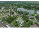 Aerial view highlights the property's location near a pond and mature trees in a residential neighborhood at 4906 Presidential St, Seffner, FL 33584