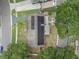 This aerial view highlights solar panels, mature landscaping, and the proximity of the shed to the home at 4906 Presidential St, Seffner, FL 33584