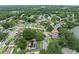 Aerial view displays a peaceful neighborhood with lush greenery and homes, some with solar panels at 4906 Presidential St, Seffner, FL 33584