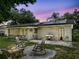 Backyard patio area featuring a fire pit, grill, and screened in porch at 4906 Presidential St, Seffner, FL 33584