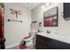 Bathroom featuring vanity, mirror, toilet, and dragonfly wall decor at 4906 Presidential St, Seffner, FL 33584