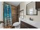 Modern bathroom featuring a vanity with a stylish faucet, a shower with decorative tiles, and a curtain at 4906 Presidential St, Seffner, FL 33584