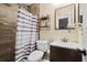 Updated bathroom includes a shower with striped shower curtain, updated vanity, and matching mirror at 4906 Presidential St, Seffner, FL 33584