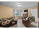 Inviting bedroom featuring wood-look floors, a comfortable chair, and a window for natural light at 4906 Presidential St, Seffner, FL 33584