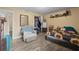 Well-lit bedroom with wood-look floors, closet, and comfortable seating, providing a cozy atmosphere at 4906 Presidential St, Seffner, FL 33584