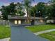 Charming single-story home with a well-maintained lawn and a gray brick exterior at 4906 Presidential St, Seffner, FL 33584