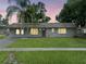 Charming single-story home with a well-maintained lawn and a gray brick exterior at 4906 Presidential St, Seffner, FL 33584