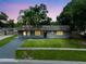 Charming single-story home with a well-maintained lawn and a gray brick exterior at 4906 Presidential St, Seffner, FL 33584