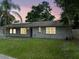 Charming single-story home with a well-maintained lawn and a gray brick exterior at 4906 Presidential St, Seffner, FL 33584