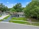 This home offers a well-manicured lawn, updated exterior paint, a mature palm tree, and solar panels at 4906 Presidential St, Seffner, FL 33584