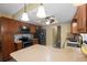 A kitchen island sits in this kitchen that features stainless appliances and dark wood cabinetry at 4906 Presidential St, Seffner, FL 33584