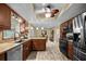 Well-lit kitchen featuring stainless steel appliances, wood cabinetry, and tile flooring at 4906 Presidential St, Seffner, FL 33584
