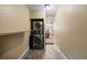 Convenient laundry area with a stacked washer and dryer, located off a hallway with wood-look floors at 4906 Presidential St, Seffner, FL 33584