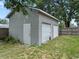 This backyard shed features both a standard door and a roll-up door for convenient storage at 4906 Presidential St, Seffner, FL 33584