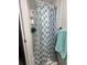 Bathroom showcasing shower with modern patterned shower curtain and convenient shower rack at 5248 Antigua Dr, Zephyrhills, FL 33541