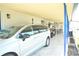 Carport featuring space for parking cars, golf carts, and an outdoor sitting area at 5248 Antigua Dr, Zephyrhills, FL 33541