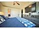 Main bedroom featuring TV, ceiling fan, and light-colored walls with a closet at 5248 Antigua Dr, Zephyrhills, FL 33541