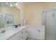 Spacious bathroom with double vanity, soaking tub, and glass-enclosed shower stall at 5814 Heronpark Pl, Lithia, FL 33547