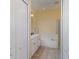 Bright bathroom featuring double sinks, a soaking tub, and a glass-enclosed shower at 5814 Heronpark Pl, Lithia, FL 33547