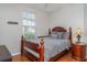 Charming bedroom featuring hardwood floors, wooden bed frame, and a sunlit window at 5814 Heronpark Pl, Lithia, FL 33547
