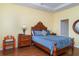 Cozy bedroom featuring hardwood floors, a wooden bed frame, and coordinating nightstands at 5814 Heronpark Pl, Lithia, FL 33547