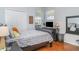 A charming bedroom with wood floors, TV, large windows, and ample natural light, perfect for relaxing at 5814 Heronpark Pl, Lithia, FL 33547