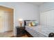 Comfortable bedroom featuring a bed, nightstand, and a view of an adjacent room through an open doorway at 5814 Heronpark Pl, Lithia, FL 33547