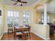 Sunny dining area with hardwood floors, bright windows and chair-rail at 5814 Heronpark Pl, Lithia, FL 33547