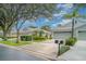 Charming home with a three-car garage, mature landscaping, and well-maintained lawn at 5814 Heronpark Pl, Lithia, FL 33547