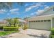 Charming home with a three-car garage, mature landscaping, and well-maintained lawn at 5814 Heronpark Pl, Lithia, FL 33547