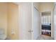Hallway view featuring a toilet, and linen closets and a view into the main bedroom at 5814 Heronpark Pl, Lithia, FL 33547