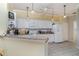 Bright kitchen featuring white cabinets, modern appliances, and a convenient breakfast bar at 5814 Heronpark Pl, Lithia, FL 33547