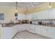 Well-lit kitchen featuring lots of white cabinets, tile floor, and modern appliances at 5814 Heronpark Pl, Lithia, FL 33547