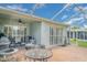 Wide shot of the lanai with a ceiling fan, grill, and outdoor seating, perfect for outdoor living at 5814 Heronpark Pl, Lithia, FL 33547