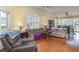 Comfortable living room with hardwood floors, ceiling fan, and plantation shutters at 5814 Heronpark Pl, Lithia, FL 33547