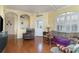 Comfortable living room with hardwood floors, ceiling fan, and plantation shutters at 5814 Heronpark Pl, Lithia, FL 33547