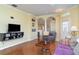 Comfortable living room with hardwood floors, ceiling fan, and plantation shutters at 5814 Heronpark Pl, Lithia, FL 33547