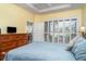 Comfortable main bedroom features hardwood flooring, tray ceiling, and shuttered windows at 5814 Heronpark Pl, Lithia, FL 33547