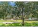 Community playground area featuring a covered playset and seating with mature trees and lush green landscaping at 5814 Heronpark Pl, Lithia, FL 33547