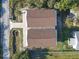 A bird's eye view of the roof and driveway of the two-story light gray home at 6602 S Sherrill St, Tampa, FL 33616