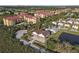 An aerial view of a light gray two-story home with brown roof near an assortment of buildings at 6602 S Sherrill St, Tampa, FL 33616
