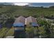An aerial view of the roof of a two-story light gray home near lush greenery at 6602 S Sherrill St, Tampa, FL 33616