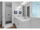 Bright bathroom featuring a double vanity, walk-in shower, and tasteful decor at 6602 S Sherrill St, Tampa, FL 33616