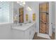 Bathroom featuring dual sinks, quartz counters, beach themed decor and shower at 6602 S Sherrill St, Tampa, FL 33616