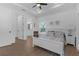 Inviting bedroom showcasing tray ceiling, wood floors, ensuite bathroom and a bright window at 6602 S Sherrill St, Tampa, FL 33616