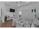 Bright bedroom with sliding glass doors leading to a balcony and a mounted television at 6602 S Sherrill St, Tampa, FL 33616