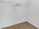 Simple walk-in closet with rod for hanging clothes and wooden floors at 6602 S Sherrill St, Tampa, FL 33616