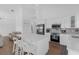 Bright kitchen boasts a large quartz island, stainless appliances, and white cabinetry at 6602 S Sherrill St, Tampa, FL 33616