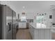 Bright kitchen features stainless appliances, an island with seating, and lots of cabinet space at 6602 S Sherrill St, Tampa, FL 33616